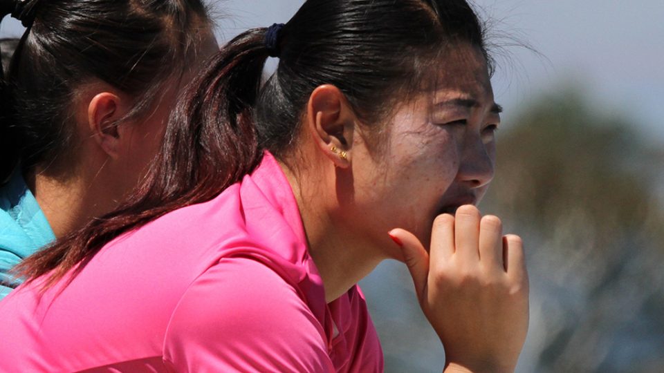 Shuai Peng watches a match from the stands