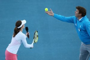 Ever seen a one-handed serve? Martina Hingis shows how it is done with the help of tournament director Mark Handley